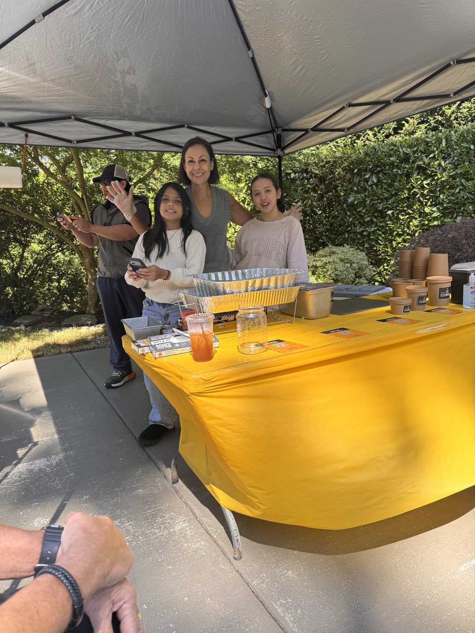 Nicole and her two daughters at the weekend driveway stand